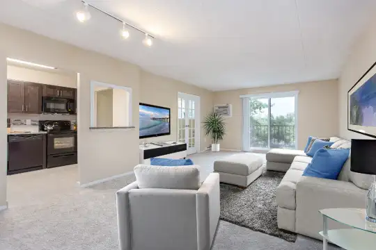 living room with tile floors, natural light, TV, dishwasher, range oven, and microwave