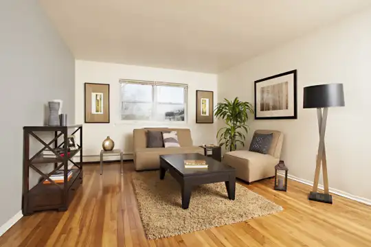 sitting room featuring hardwood floors, natural light, and baseboard radiator