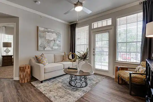 living room with hardwood floors and a ceiling fan