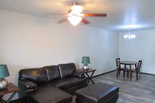 hardwood floored living room featuring a ceiling fan