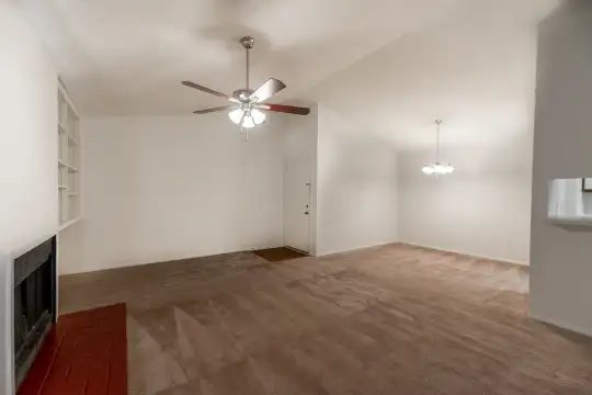 living room with a ceiling fan, carpet, and a fireplace