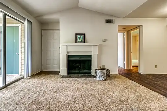 living room with carpet and a fireplace