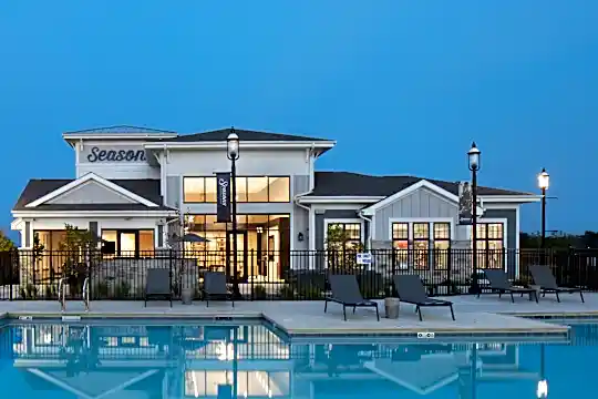 back of property featuring a swimming pool