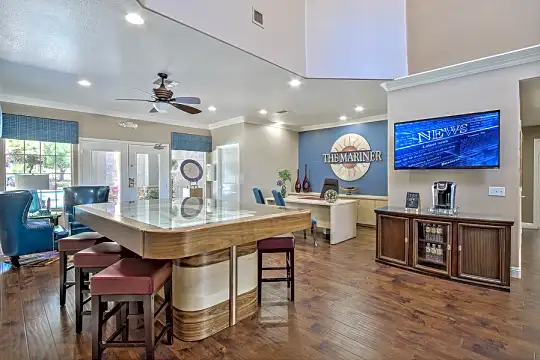 bar with a ceiling fan, natural light, TV, light granite-like countertops, dark brown cabinets, and dark hardwood floors