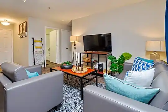 hardwood floored living room featuring TV