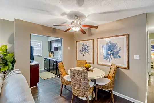 hardwood floored dining room with a ceiling fan and dishwasher