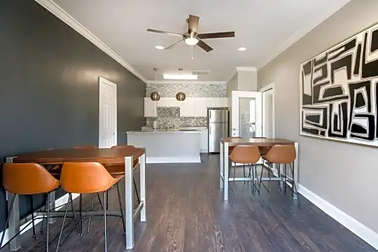 hardwood floored dining space featuring a ceiling fan and refrigerator