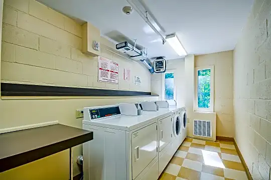 laundry area featuring plenty of natural light, tile floors, and washer / dryer