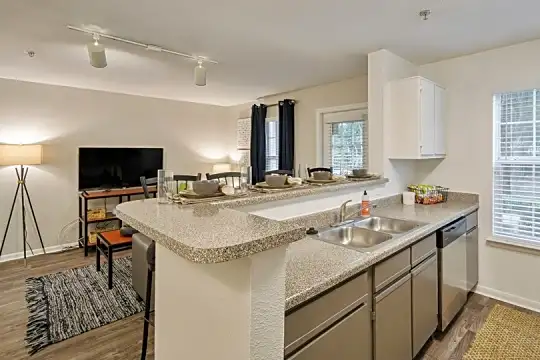 kitchen featuring a healthy amount of sunlight, TV, dishwasher, light hardwood floors, white cabinetry, and light stone countertops