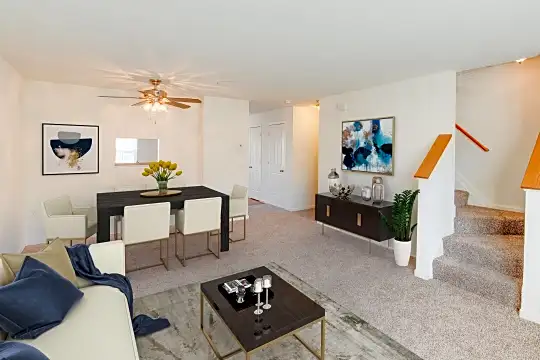 living room with a ceiling fan and carpet