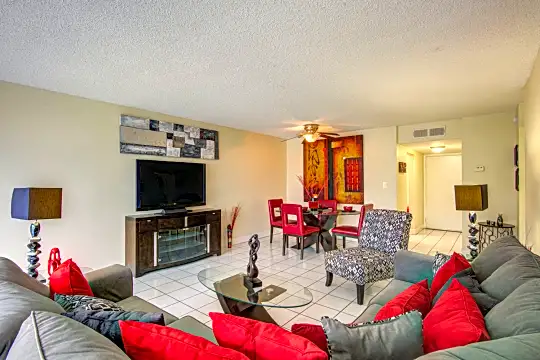 living room featuring tile flooring, a ceiling fan, and TV
