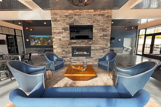 building lobby with a fireplace, natural light, and TV