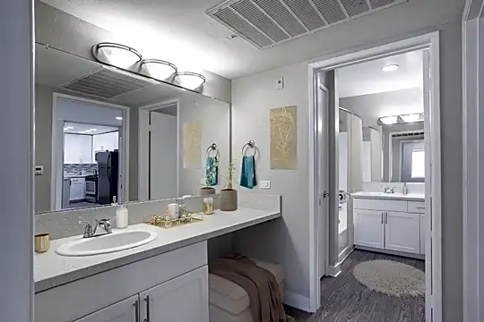 bathroom featuring his and hers vanities and dual mirrors