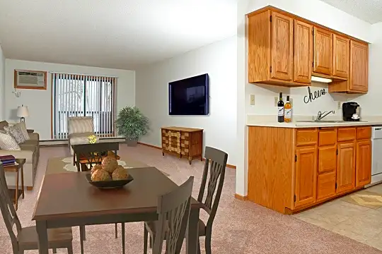 carpeted dining area featuring dishwasher and TV