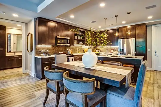 dining area with hardwood floors and stainless steel appliances