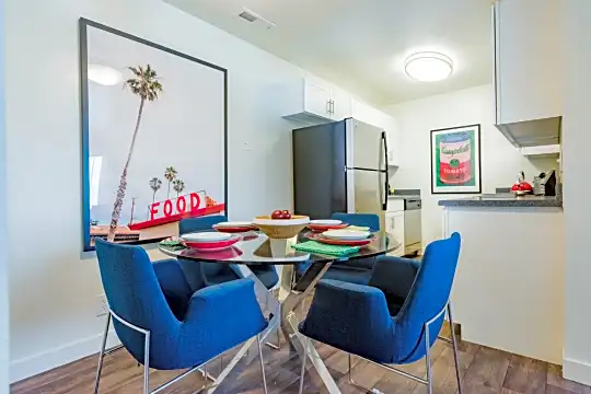 dining area with hardwood floors and refrigerator