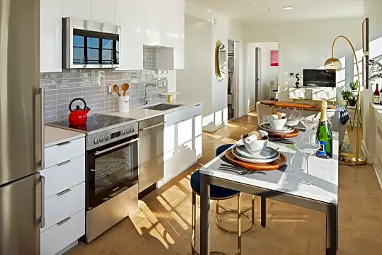 kitchen featuring refrigerator, microwave, stainless steel dishwasher, electric range oven, TV, light parquet floors, white cabinets, and light countertops