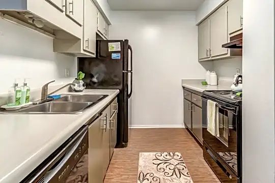 kitchen with electric range oven, refrigerator, dishwasher, fume extractor, white cabinetry, and light hardwood floors