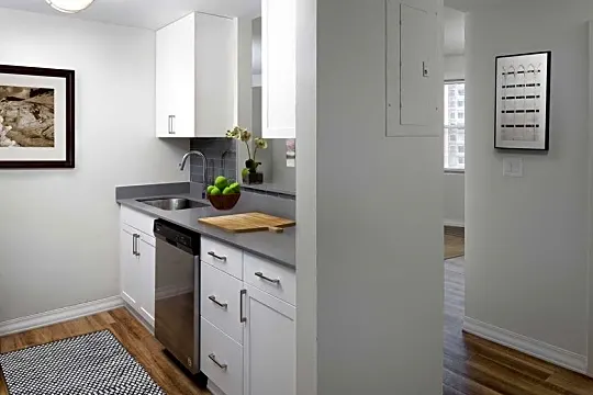 kitchen featuring dishwasher, dark parquet floors, white cabinetry, and dark countertops