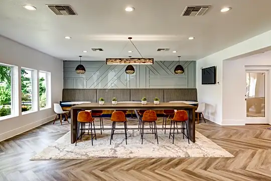 dining area with parquet floors, natural light, and TV