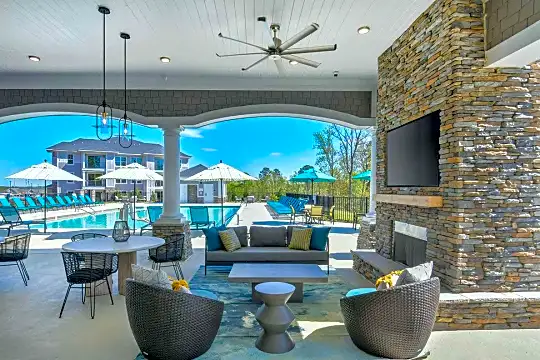 view of patio with a ceiling fan, an outdoor living space with a fireplace, and a pool
