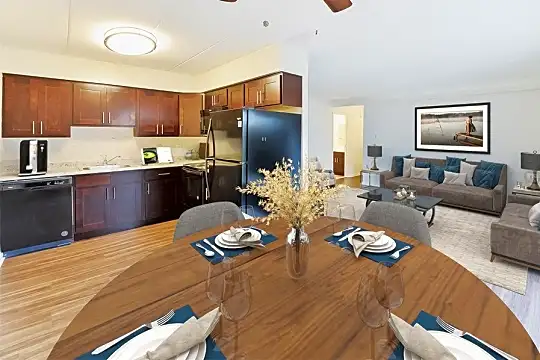dining room featuring hardwood flooring, refrigerator, and dishwasher