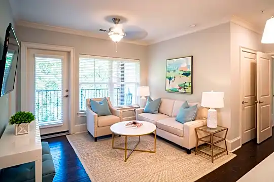 living room featuring hardwood floors, natural light, a ceiling fan, and TV
