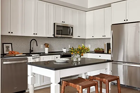 kitchen featuring range oven, stainless steel appliances, dark parquet floors, dark countertops, and white cabinetry