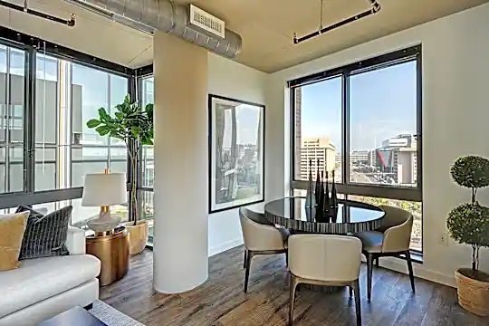 sunroom featuring parquet floors and a healthy amount of sunlight