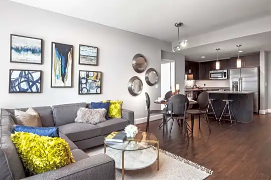 living room featuring hardwood floors, microwave, and stainless steel refrigerator