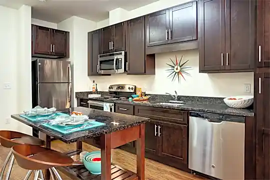 kitchen with electric range oven, stainless steel appliances, dark granite-like countertops, light flooring, and dark brown cabinets