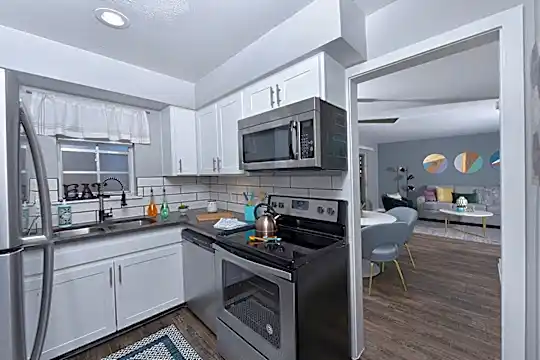 kitchen featuring electric range oven, stainless steel appliances, dark parquet floors, dark countertops, and white cabinetry