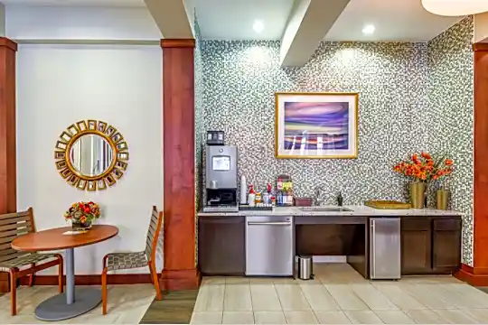 welcome area featuring tile floors and stainless steel dishwasher