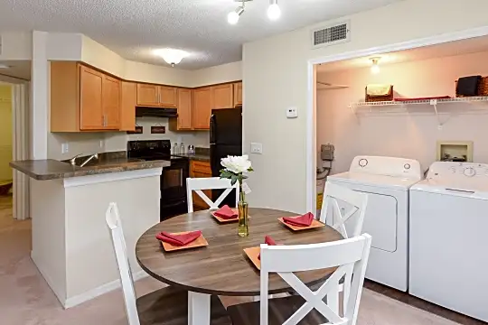 laundry room with tile floors, separate washer and dryer, ventilation hood, and range oven