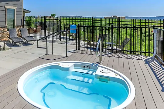 view of swimming pool featuring a jacuzzi and a deck