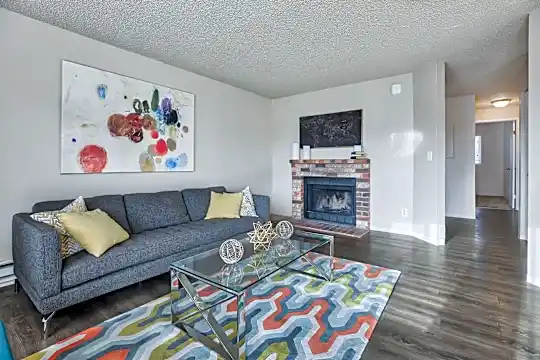 living room with hardwood floors, a fireplace, and baseboard radiator