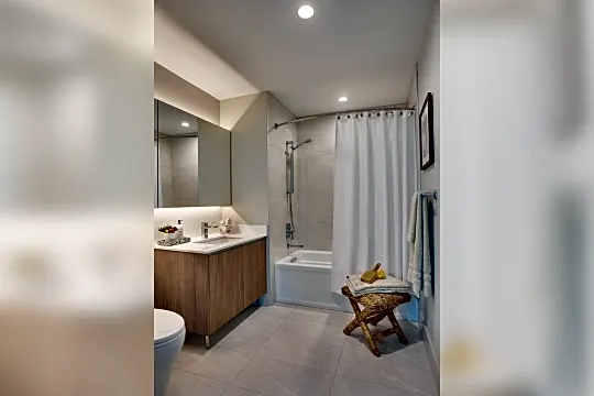 full bathroom with tile flooring, mirror, shower / bath combination, toilet, shower curtain, and large vanity