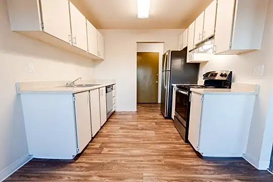 kitchen featuring electric range oven, refrigerator, ventilation hood, dishwasher, light parquet floors, white cabinets, and light countertops