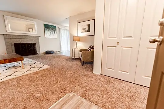 living room with carpet and a fireplace