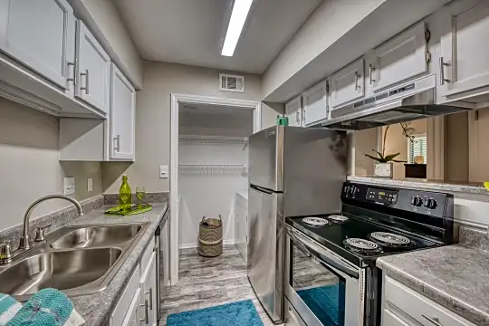 kitchen with range hood, electric range oven, dishwasher, white cabinetry, stone countertops, and light tile floors