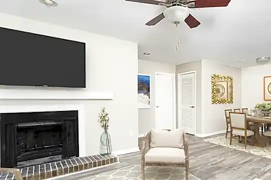 living room with a ceiling fan, a fireplace, and TV