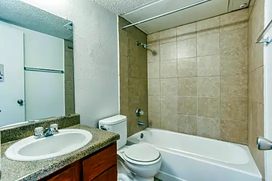 full bathroom featuring shower / bathing tub combination, toilet, mirror, and vanity