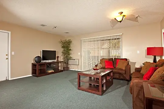 carpeted living room featuring TV