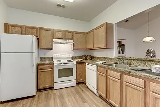 kitchen with range hood, refrigerator, electric range oven, dishwasher, dark granite-like countertops, light hardwood floors, pendant lighting, and brown cabinetry