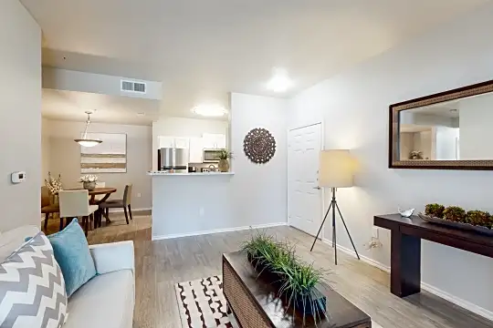 living room featuring hardwood flooring, refrigerator, and microwave