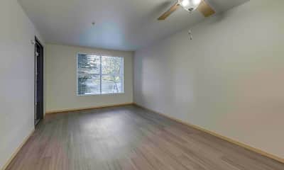 hardwood floored empty room featuring natural light, lofted ceiling, and a ceiling fan, Promenade At The Park, 2
