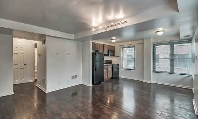 hardwood floored living room featuring a wealth of natural light, refrigerator, range oven, and microwave, The Maynard at 2529 W Fitch, 1
