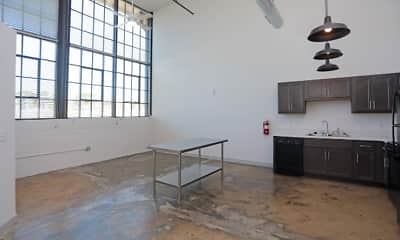 kitchen with a wealth of natural light, refrigerator, dishwasher, pendant lighting, light countertops, dark brown cabinets, and dark floors, Printworks Mill, 1