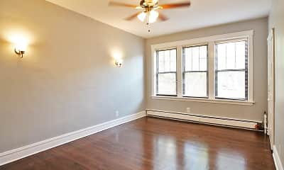 empty room with a ceiling fan, hardwood floors, natural light, and baseboard radiator, 902-910 N. Austin Boulevard, 1