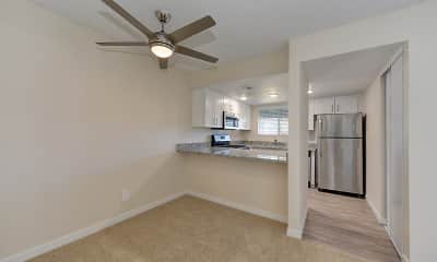 kitchen with a ceiling fan, carpet, natural light, stainless steel refrigerator, range oven, microwave, granite-like countertops, light flooring, white cabinetry, and pendant lighting, West Oaks Apartments, 2